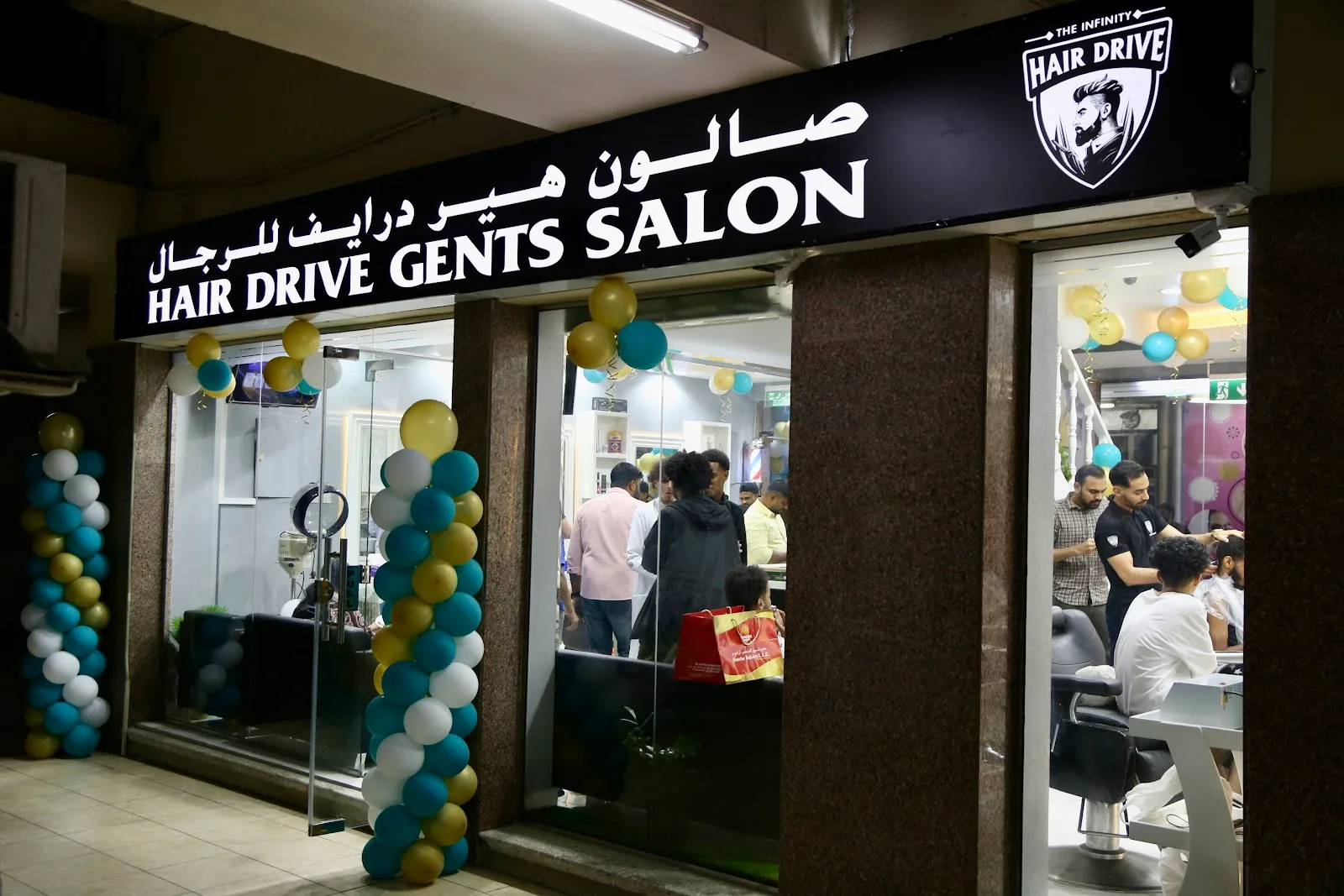 HAIR DRIVE Gents Salon storefront decorated with teal and gold balloons on opening night
