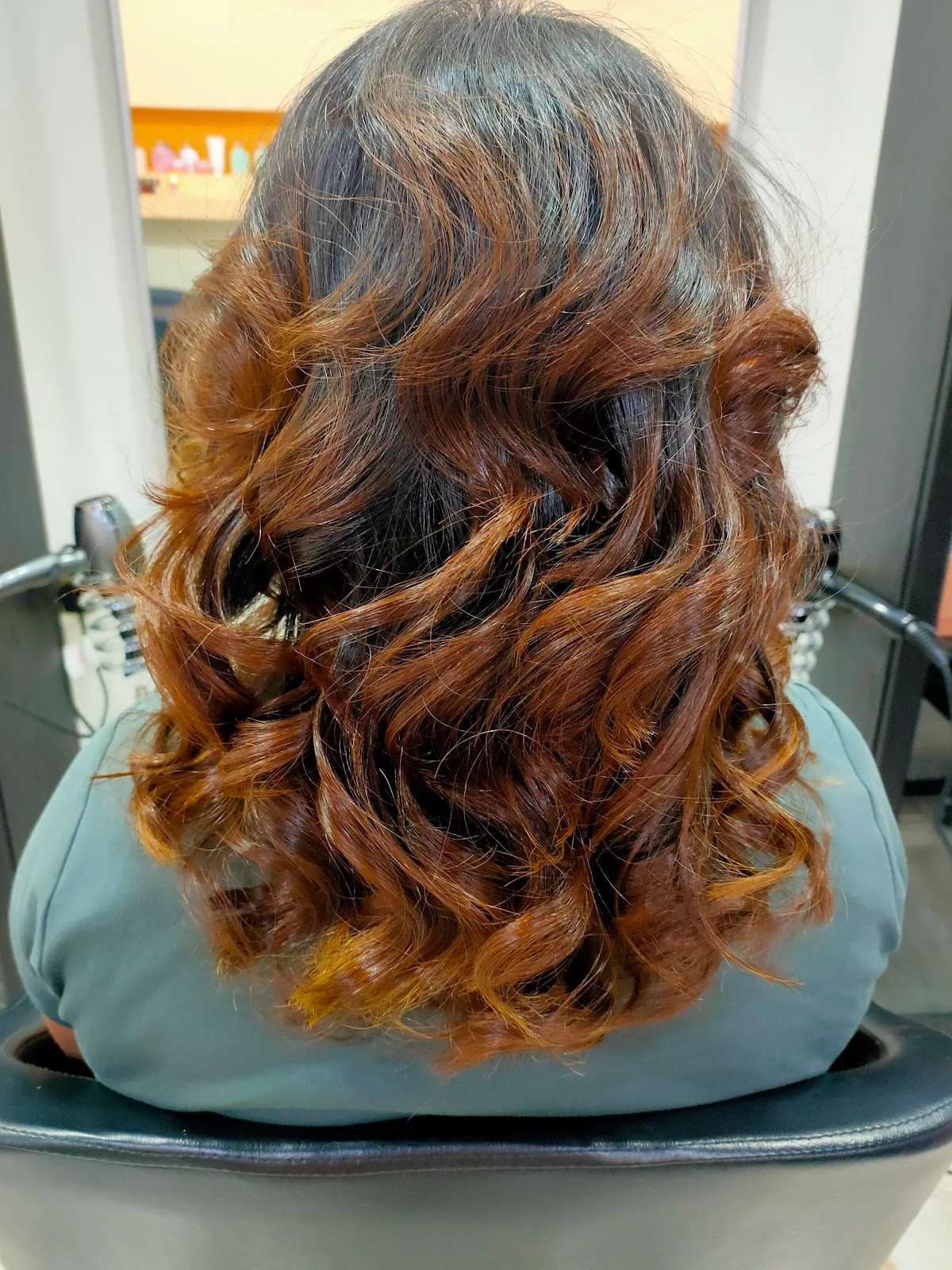 Auburn curls styled from the back