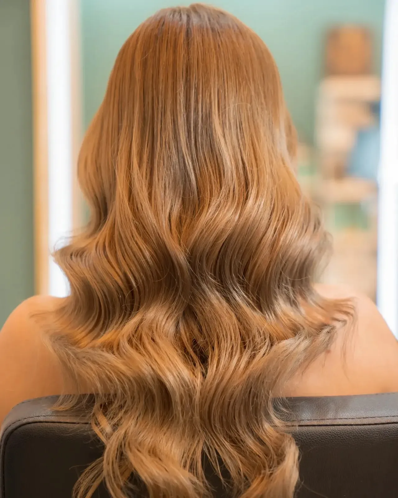 Long warm caramel waves styled at Lara Beauty Salon