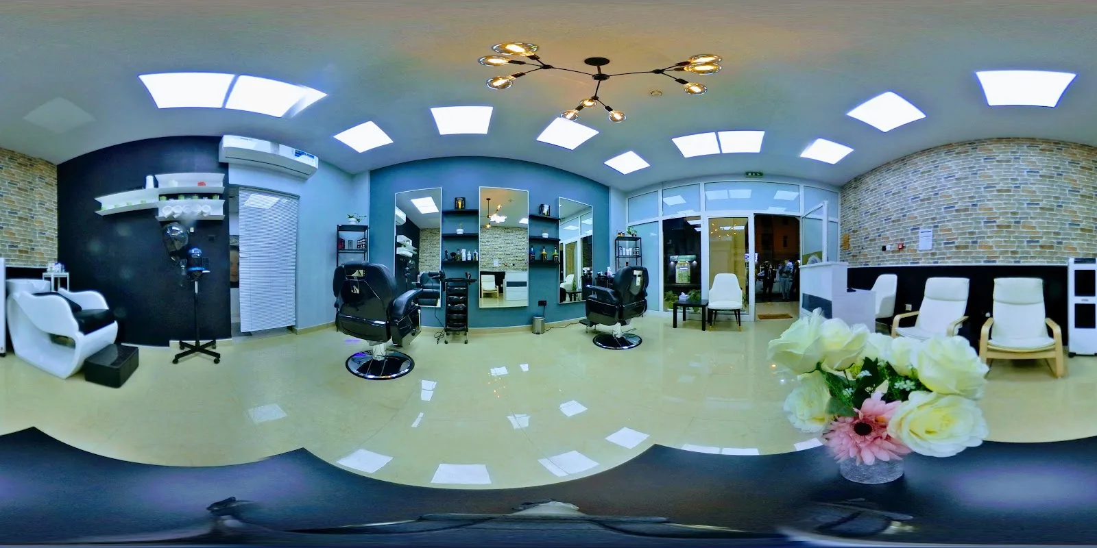 Wide view of the AlaDin Gents Saloon interior with waiting chairs and styling stations