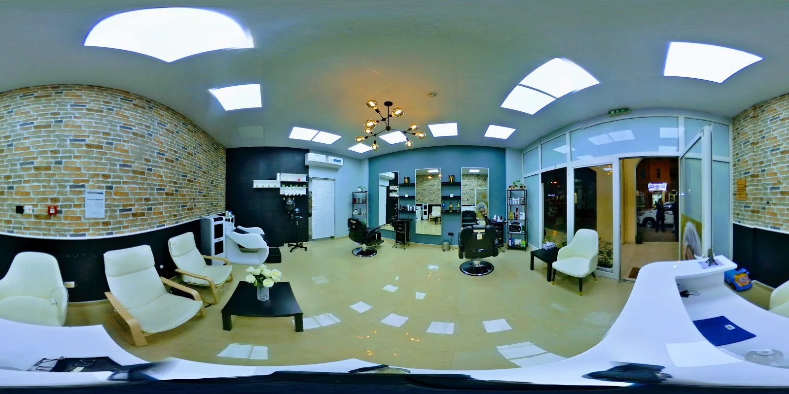 Bright waiting area with cushioned chairs and brick feature wall