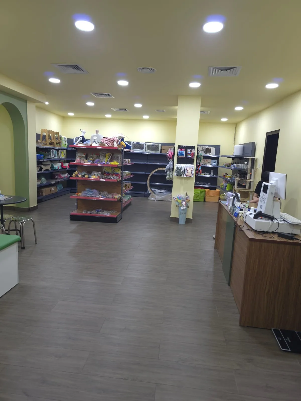 Inside Pet Moment: shelves of pet supplies and a tidy front counter