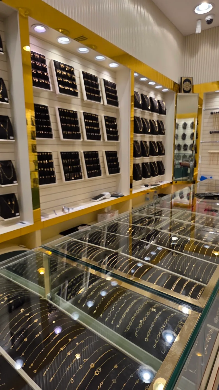 Gold chains displayed in a glass counter at Top Pure Jewellery