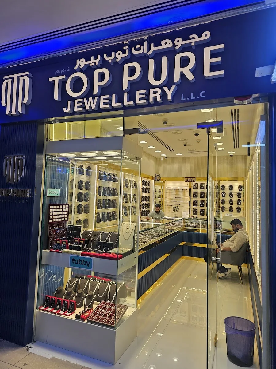 Top Pure Jewellery storefront at Shop 28, Al Attar Centre, Al Karama, Dubai, with illuminated TP sign