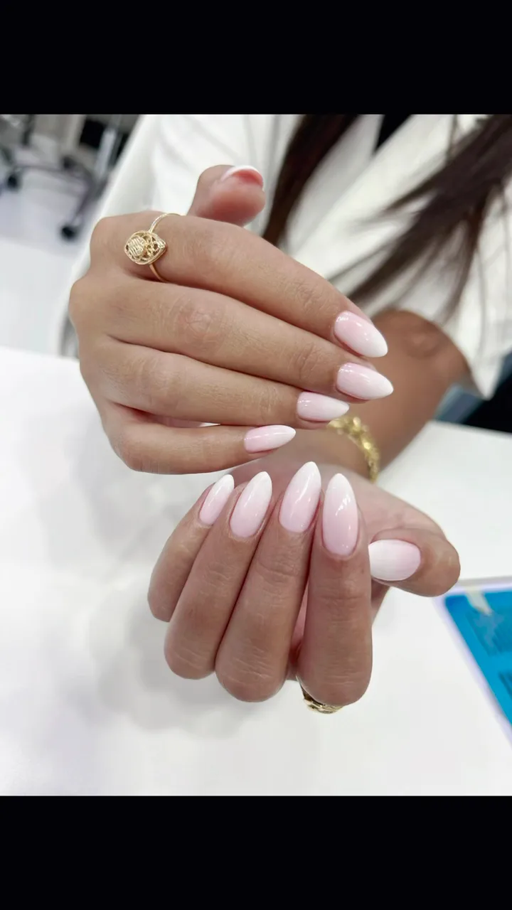 Almond-shaped nails in a soft pink and white ombré gel finish