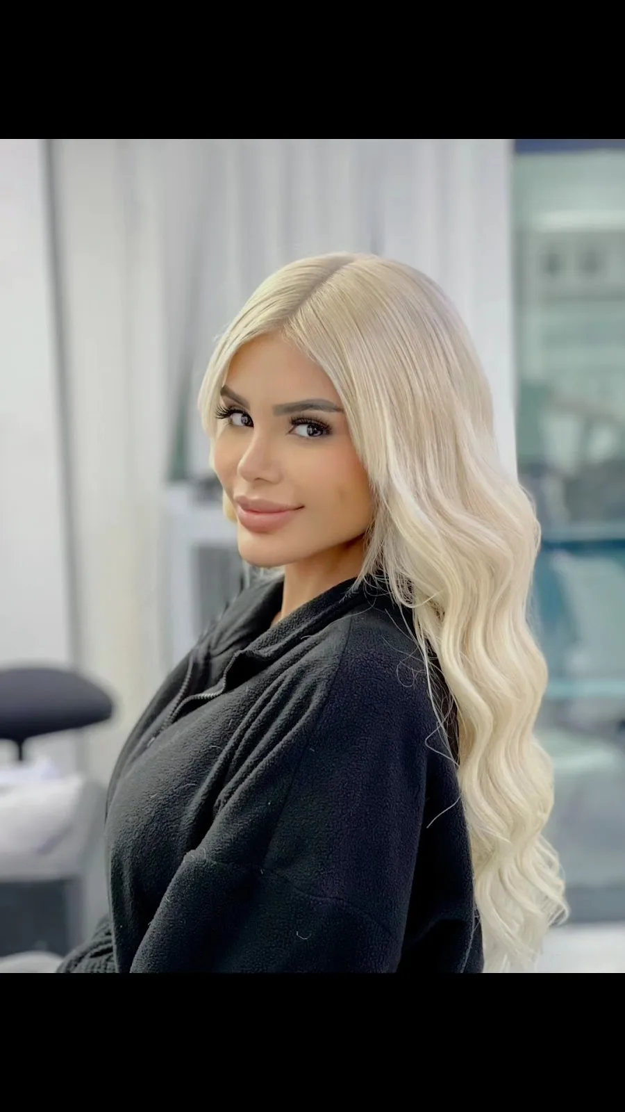 Long blonde hair styled in soft waves