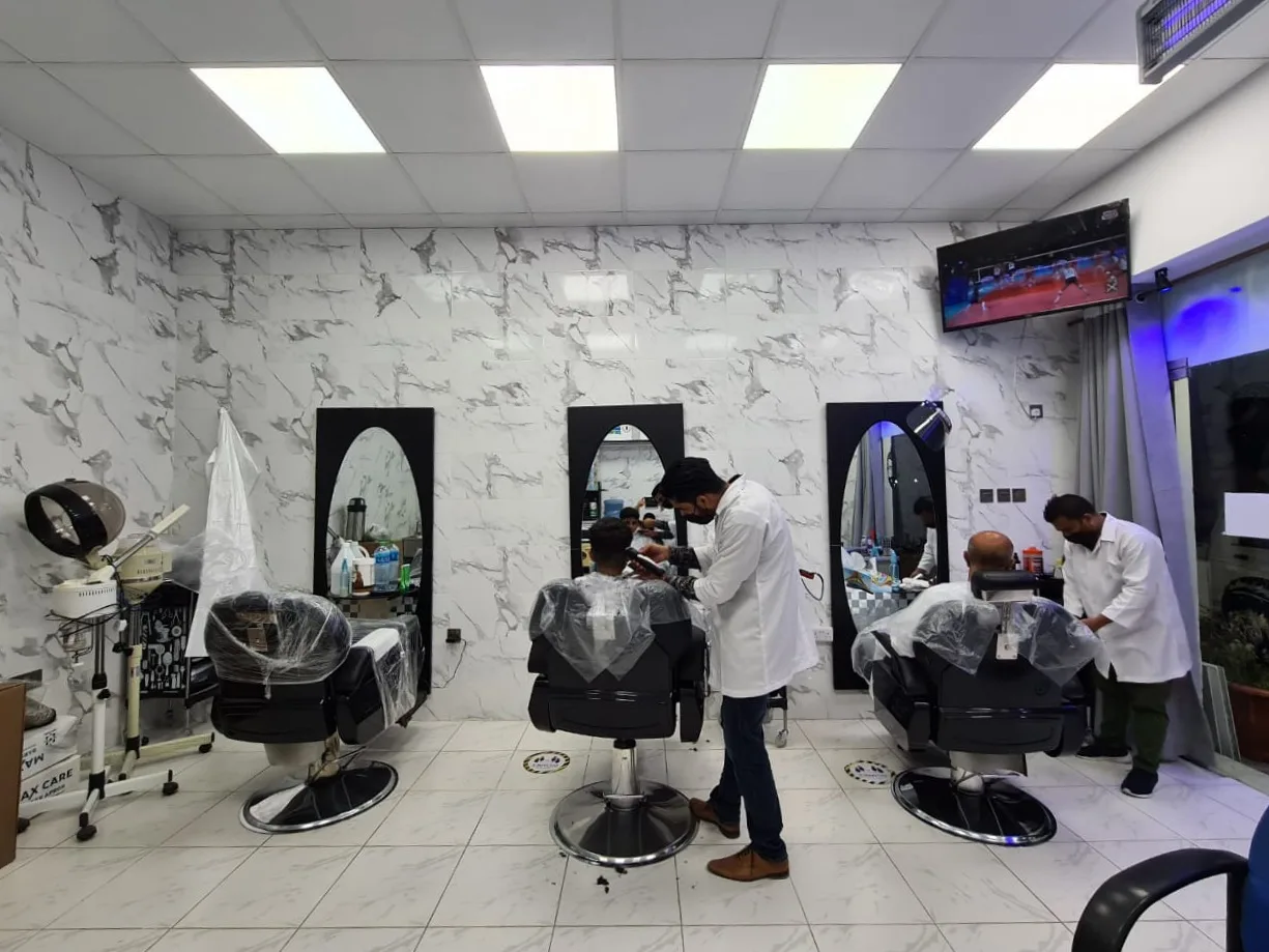 Inside Al Shabab Gents Saloon — barber stations with marble walls