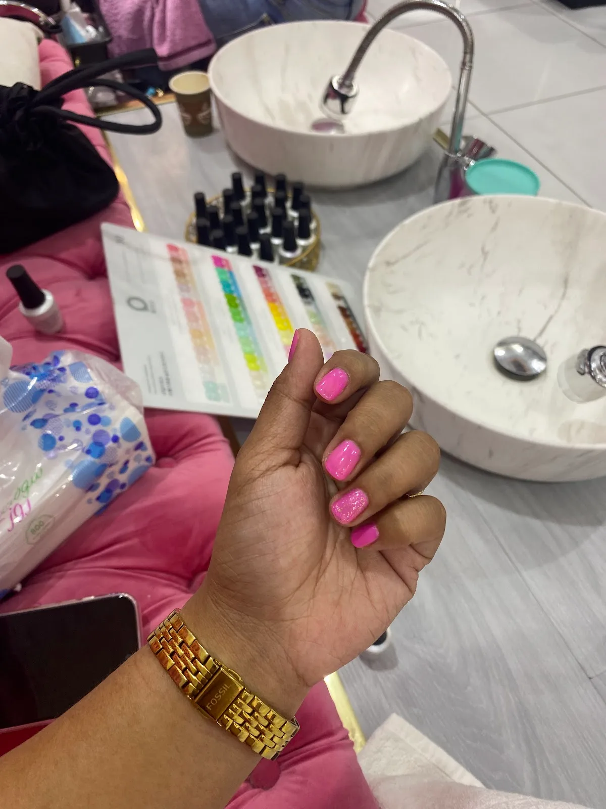 Bright pink manicure at the marble nail bar with a shade chart