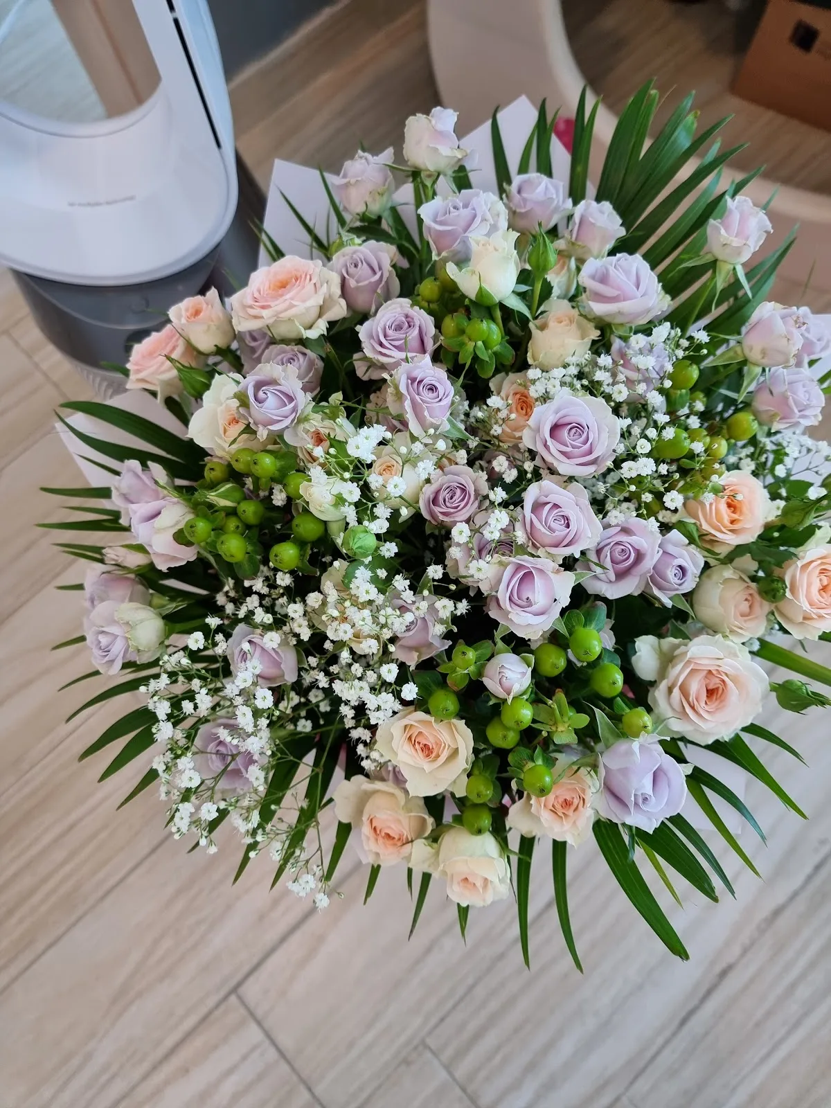 Soft lavender and peach roses in an overhead bouquet