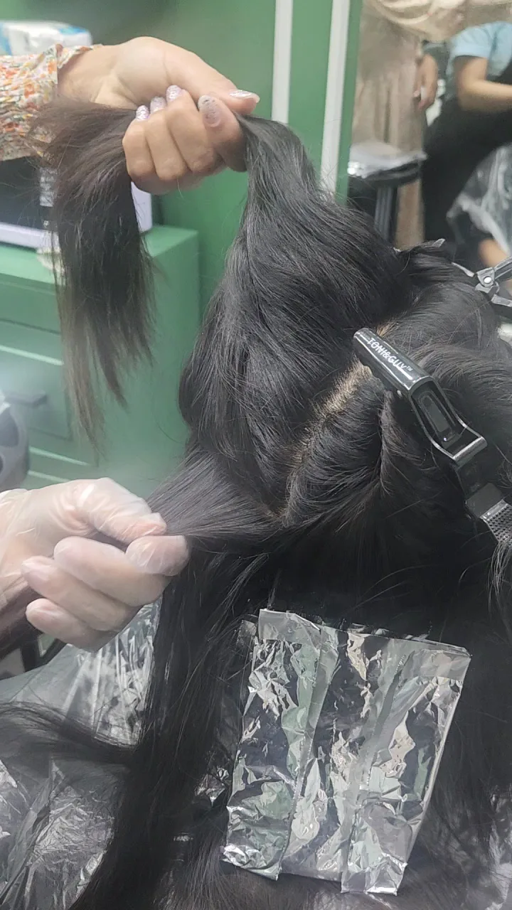 Hair colour application with foils in progress